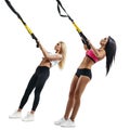 Fitness women do thrust with trx suspension Royalty Free Stock Photo