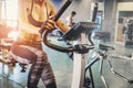 Fitness woman working out on exercise bike at the gym