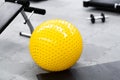 Fitness on wooden floor. Sports balls. Yoga ball in fitness room.Exercise yellow color ball in fitness, gym equipment and fitness Royalty Free Stock Photo