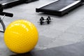 Fitness on wooden floor. Sports balls. Yoga ball in fitness room.Exercise yellow color ball in fitness, gym equipment and fitness Royalty Free Stock Photo