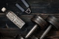 Fitness workout equipment. Dumbbell or barbell on a wooden floor surface. Flat lay desaturated concept Royalty Free Stock Photo