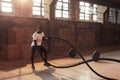 Fitness workout. Sport man doing battle rope exercise at gym Royalty Free Stock Photo