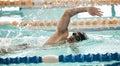 Fitness, workout and a swimmer in a pool during a race, competition or cardio training at a gym. Exercise, water and Royalty Free Stock Photo