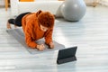 Fitness Workout training. Young healthy fit african girl doing plank exercise on yoga mat on floor at home. Athletic Royalty Free Stock Photo