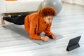 Fitness Workout training. Young healthy fit african girl doing plank exercise on yoga mat on floor at home. Athletic Royalty Free Stock Photo