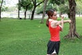 Fitness young Asian woman stretching her hands before run in park. Workout and exercise concept Royalty Free Stock Photo