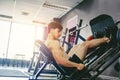 Fitness young man exercising using rowing machine in the gym Royalty Free Stock Photo