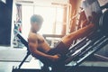 Fitness young man exercising using rowing machine in the gym Royalty Free Stock Photo