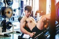 Fitness young man exercising using rowing machine in the gym Royalty Free Stock Photo