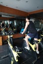 Asian chinese Fitness young man on gym bike spinning Royalty Free Stock Photo