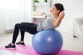 Fitness young woman doing abdominal crunches on fit ball. Royalty Free Stock Photo