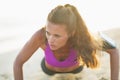 Fitness young woman doing push ups on beach Royalty Free Stock Photo