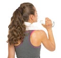 Fitness young woman drinking water . rear view Royalty Free Stock Photo