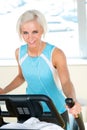 Fitness young woman on elliptical cross trainer