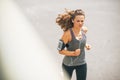 Fitness young woman jogging outdoors in the city Royalty Free Stock Photo