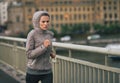 Fitness young woman jogging in rainy city Royalty Free Stock Photo