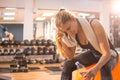 Fitness young woman resting on fitness ball in gym Royalty Free Stock Photo