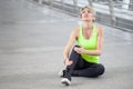 fitness young woman Running injury leg accident of workout exercising on street in urban city . sport runner girl sitting on floor Royalty Free Stock Photo