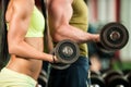 Fitness youple workout - fit mann and woman train in gym Royalty Free Stock Photo