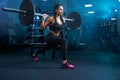 Fitnessoman practicing lunges using barbell in gym. Royalty Free Stock Photo