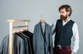 Fits perfect. Man clothing in boutique. Man with suit. tailor in his workshop. Handsome bearded fashion man in classical