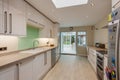 Fitted kitchen with pale green splashback Royalty Free Stock Photo