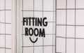 Fitting Room sign close up in mall store shop retail clothing changing door entrance with nobody on wall Royalty Free Stock Photo