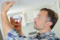 Fitting smoke alarm to be safe Royalty Free Stock Photo