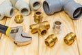 Fittings and spare parts, accessories for plumbing repair on a wooden boards