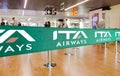 Green ribbon barrier with the ITA airways logo inside the Leonardo da Vinci international airport in Rome Fiumicino in Italy