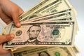 Five 5 American dollars banknote money bill in the hand of a young child features profile of a portrait of Abraham Lincoln, the Royalty Free Stock Photo