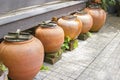 Five ancient orange jars are arranged together