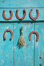 Five antique rusty horseshoe and wheat ears bunch on wall Royalty Free Stock Photo