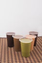 Five assorted iced cafe beverages in plastic cups arranged on a traditional brown woven mat Royalty Free Stock Photo
