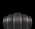 Five automobile rubber tires isolated on black