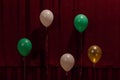 Five balloons of different colors on a red background. For decoration design of the holiday. Royalty Free Stock Photo