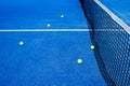 five balls on a blue paddle tennis court near the net, racket sports concept Royalty Free Stock Photo