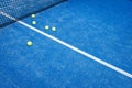 Five balls near the net in a blue paddle tennis court, racket sports concept Royalty Free Stock Photo