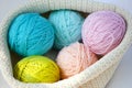 Five balls of wool - blue, light blue, yellow, pink and pale pink