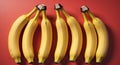 Five Bananas Arranged in a Row on a Red Background. Royalty Free Stock Photo