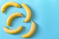 Five bananas on a blue pastel background. Minimal concept