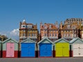 Five Beach huts infront of traditional Hove buildings Royalty Free Stock Photo