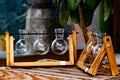 Five beakers on wood frames
