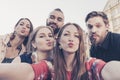Five best friends take a selfie making kiss expression duckface