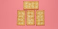 Five biscuits overlapped against a pink background