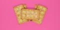 Five biscuits overlapped against a pink background