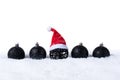 Five Black christmas balls with snow and Santa Hat isolated on white background Royalty Free Stock Photo