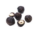 Five black peppercorns isolated on white background Royalty Free Stock Photo