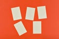 Five blank sticky notes on red paper background or on the board