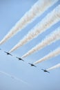 Five blue angel jets flying overhead in sync